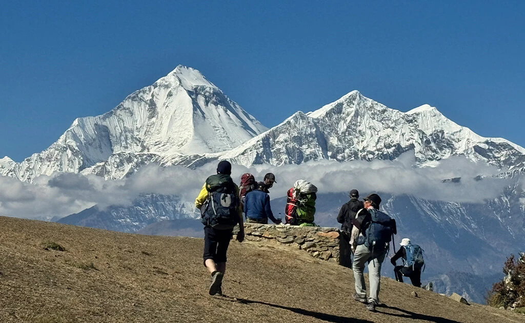 Trekkers admire stunning Dhaulagiri view from Lupra Village,Breathtaking view of Dhaulagiri from Lupra Village Mustang