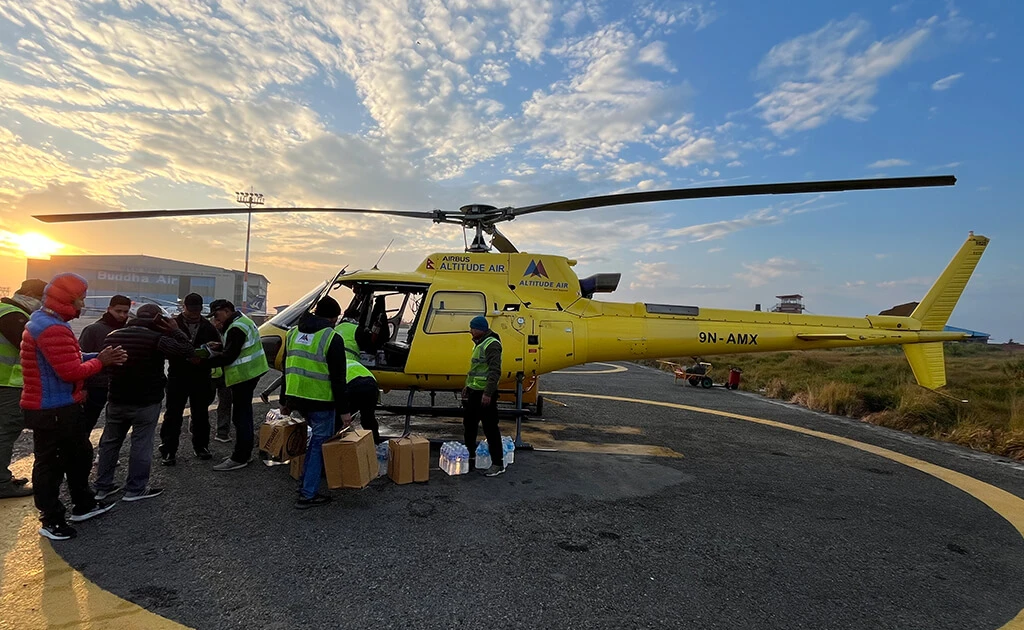 Helicopter being loaded by crew for the Langtang Heli Tour.