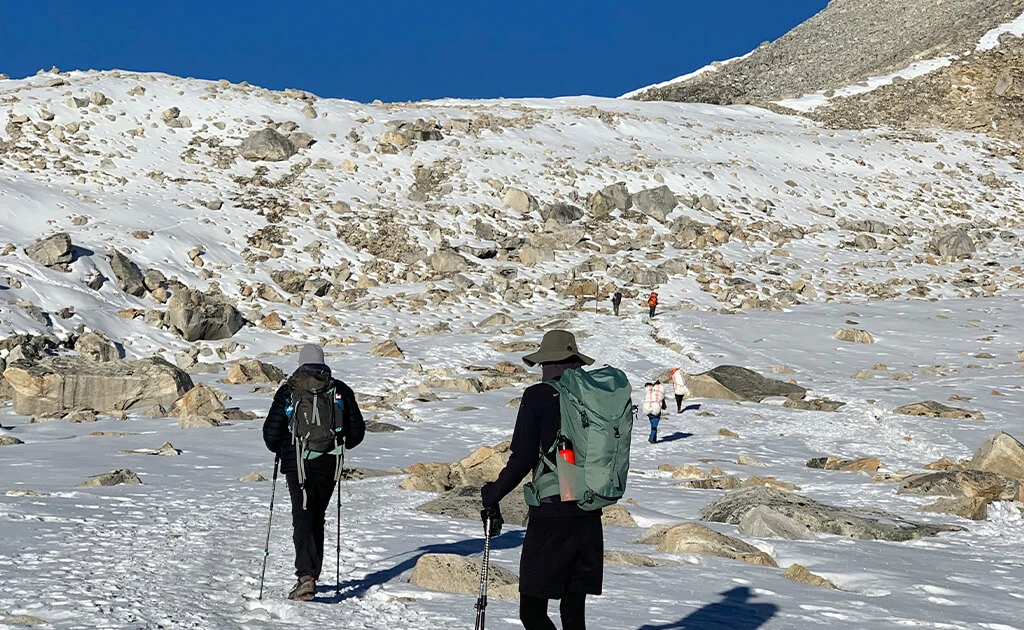 Hikers on a snowy mountain trail