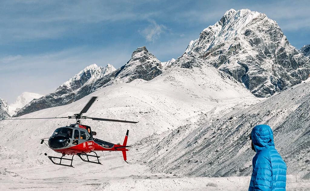 Helicopter landing in snowy Himalayan mountains