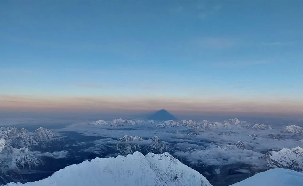 The massive, triangular shadow of Mount Everest cast at sunrise