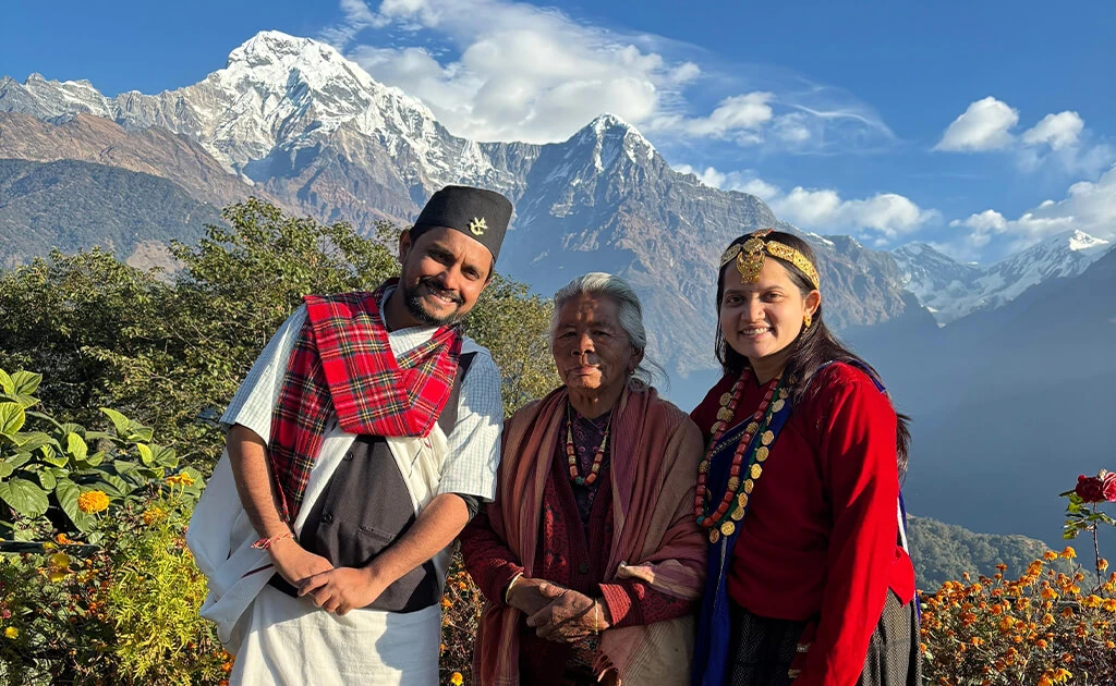 Visitors in traditional Gurung dress at Ghandruk with Annapurna mountain view