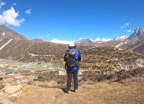 Trekker overlooking Gokyo Valley with Himalayan landscapes in the Everest region