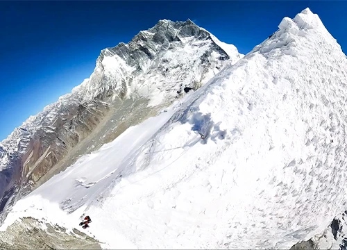 Climbers ascending snowy ridge near Island Peak summit